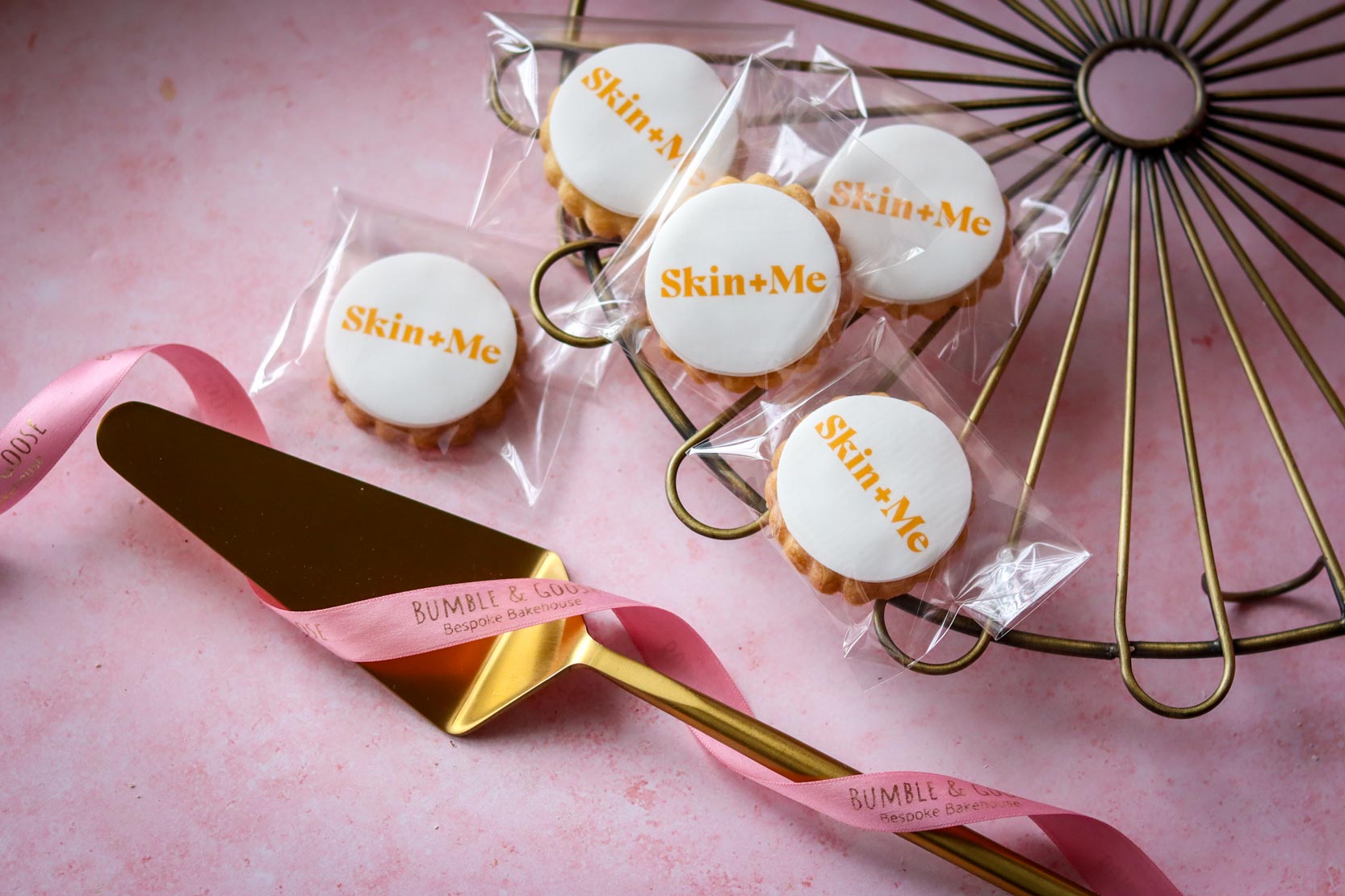 Skin+Me branded biscuits with orange logo print custom personalised biscuits London brand event Bumble & Goose